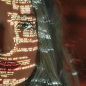 Abstract cyberpunk portrait with code projected on a woman's half face, symbolizing technology integration.